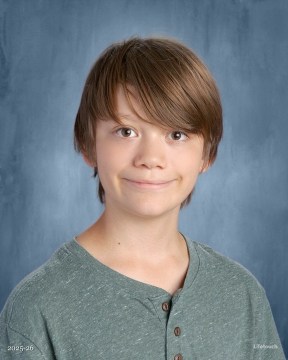 3GWXZXP4-103324.jpeg William smiling in a green shirt